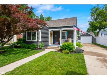 Charming home with a welcoming front porch, landscaped lawn, and detached garage at 188 Maple Ln, Franklin, IN 46131