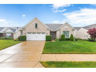 Charming brick ranch home with a well-manicured lawn and two car garage at 18991 Round Lake Rd, Noblesville, IN 46060