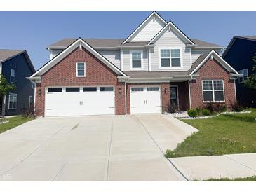 Two-story home featuring a brick-accented facade, light gray siding, and a spacious two-car garage at 2358 S Stonehill Way, New Palestine, IN 46163