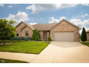 Charming brick home with a well-manicured lawn and a two-car garage at 3717 Bellmore Dr, Brownsburg, IN 46112