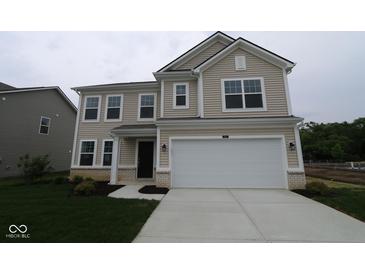 Charming two-story home featuring a two-car garage, neutral siding and manicured lawn at 3917 Highcrest Rd, Indianapolis, IN 46239
