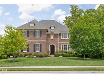 Beautiful two-story brick home with manicured lawn and professional landscaping at 4529 Panthera Leo Dr, Carmel, IN 46074