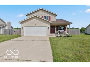 Inviting two-story home with a well-manicured lawn and a convenient two-car garage at 4605 Clairmont Dr, Columbus, IN 47203