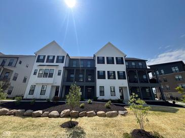Inviting exterior view of new townhome with professional landscaping and craftsman style architecture at 473 Mariposa Trl, Carmel, IN 46032