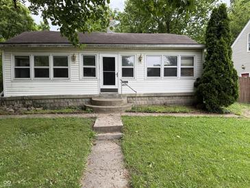 Charming single-story home with a well-maintained front yard and inviting entrance at 4931 Orion Ave, Indianapolis, IN 46201