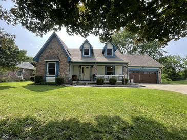 Charming two-story home featuring a welcoming front porch and well-manicured lawn at 530 Denny Dr, Mooresville, IN 46158