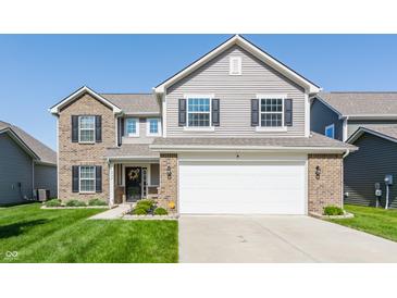 Two-story home featuring a two-car garage, brick accents, and a well-manicured lawn at 5794 Cherrywood Ln, McCordsville, IN 46055