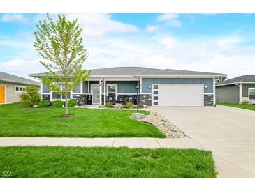 Charming single-story home with a manicured front yard, stone accents, and a two-car garage at 655 N Sobota Way, Trafalgar, IN 46181