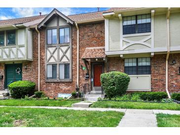 A brick townhome featuring a well-maintained front yard and a charming entrance at 8121 Bromley Pl, Indianapolis, IN 46219