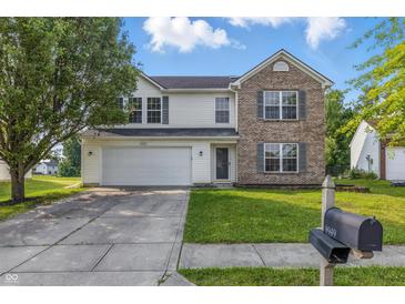 Charming two-story home with brick accents, a well-manicured lawn, and an attached two-car garage at 9949 Nightsong Ln, Avon, IN 46123