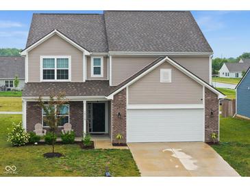 Charming two-story home featuring a well-manicured lawn and an attached two-car garage at 10118 Falls Canyon Ln, Indianapolis, IN 46229