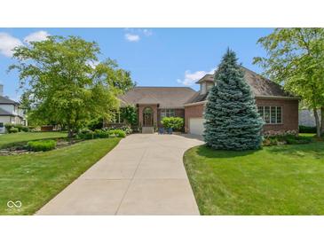 Charming brick home featuring a well-manicured lawn and a long driveway leading to an attached garage at 11761 Darsley Dr, Fishers, IN 46037