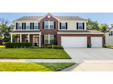 Charming two-story home with a well-manicured lawn and a two car attached garage at 1343 Turfway Dr, Avon, IN 46123