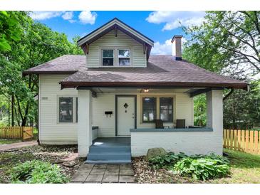 Charming two-story home with a covered front porch, landscaped yard, and classic architectural details at 1511 E Edwards Ave, Indianapolis, IN 46227