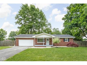 Charming red brick ranch home with a well-manicured lawn and attached two-car garage at 258 N Green Springs Rd, Indianapolis, IN 46214