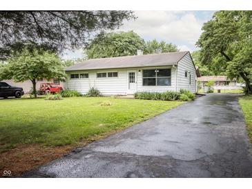 Charming one-story home featuring a well-manicured lawn and asphalt driveway at 4020 Alden Ave, Indianapolis, IN 46221