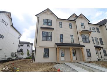 New two-story townhome features neutral siding, black trimmed windows, and covered front entry at 4181 Barrel Ln, Westfield, IN 46062