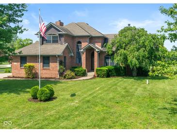 Charming two-story brick home featuring an inviting front yard and an American flag at 4287 Gibbs Rd, Danville, IN 46122