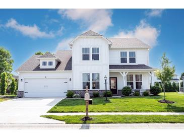 Charming two-story home with a manicured lawn, a two-car garage, and a covered front porch at 4992 Fennel Dr, Pittsboro, IN 46167