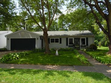Charming single-story home with well-maintained lawn and mature trees at 509 Eberhart Dr, Shelbyville, IN 46176