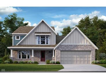 Charming two-story home featuring brick and siding accents, a cozy porch, and an attached two-car garage at 527 Firefly Ct, Greenfield, IN 46140