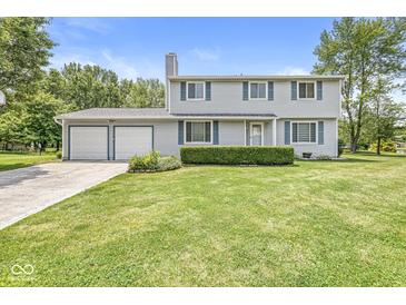 Traditional two-story home with blue shutters, an attached two-car garage, and a lush green lawn at 6601 Valley Forge Ct, Indianapolis, IN 46237