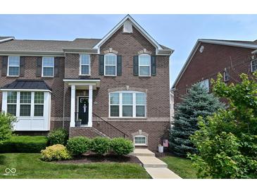 Charming two-story brick home with well-maintained landscaping and inviting front entrance at 13616 Whitten N Dr, Fishers, IN 46037