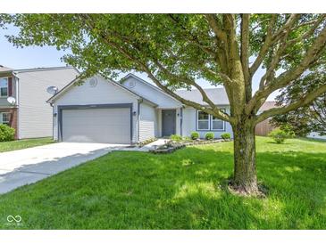 Charming single-story home with a well-maintained lawn and attached two-car garage at 14255 Holly Berry Cir, Fishers, IN 46038