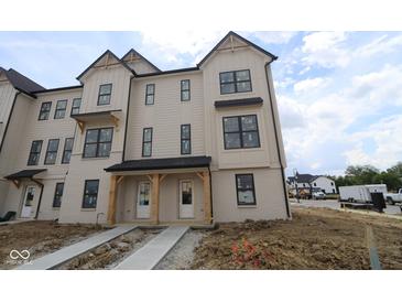 Newly constructed two-story townhome showcasing modern farmhouse style with neutral siding and black trim at 4141 Barrel Ln, Westfield, IN 46062