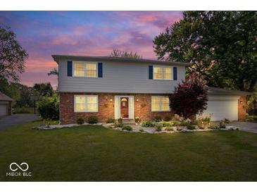 Charming two-story home with brick and vinyl exterior, landscaped yard, and inviting front entrance at 6133 Buttonwood Dr, Noblesville, IN 46062