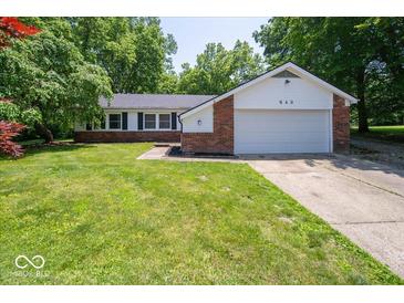 Inviting one-story home with manicured lawn, mature trees, and attached two-car garage at 640 Shady Creek Ct, Greenwood, IN 46142