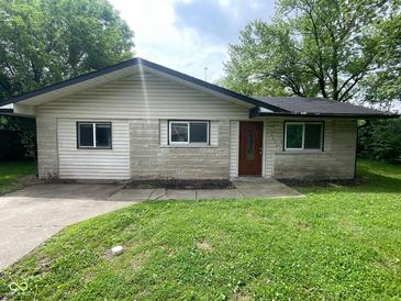 Cozy single-story home with a well-maintained lawn and inviting front entrance at 9045 Stardust Dr, Indianapolis, IN 46229