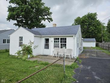 Charming single-story home with a white exterior and well-maintained front yard at 1102 S Dequincy St, Indianapolis, IN 46203