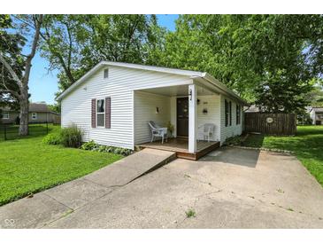 Charming one-story home with a covered porch and landscaped front yard, offering a welcoming curb appeal at 1120 W 5Th St, Greenfield, IN 46140