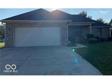 Charming single-story home with a brick facade, well-maintained lawn, and attached two-car garage at 1128 Brookside Ct, Avon, IN 46123