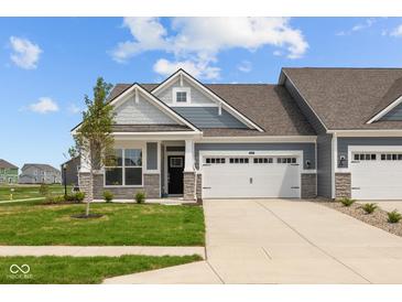 Charming home featuring a two-car garage, stone accents, and a well-maintained lawn, creating an inviting curb appeal at 12490 Morning Ridge Way, Noblesville, IN 46060