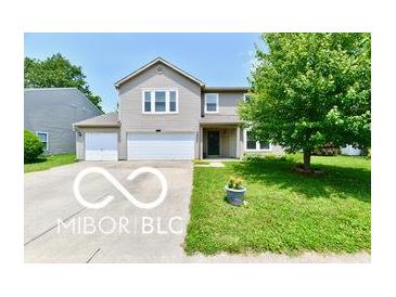 Charming two-story home with a well-maintained lawn, a two-car garage, and attractive landscaping at 1252 Jasmine Dr, Greenfield, IN 46140