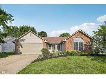 Charming single-story home with a manicured lawn, brick accents, and an attached two-car garage at 12848 Patrick Ct, Fishers, IN 46038