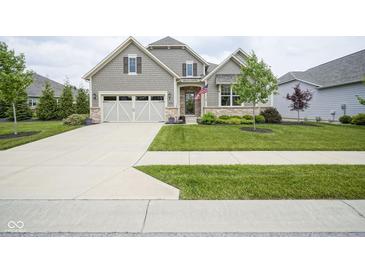 Charming home features a manicured lawn, two-car garage, and inviting walkway at 16209 Natures Way, Westfield, IN 46074