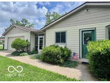 Charming single-story home with a well-maintained lawn, lush shrubs, and an inviting entrance at 1802 Laurel Dr, Columbus, IN 47203
