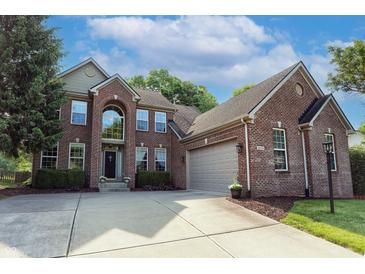 Beautiful two-story brick home with a manicured lawn, a two-car garage, and a concrete driveway at 18112 Kinder Oak Dr, Noblesville, IN 46062