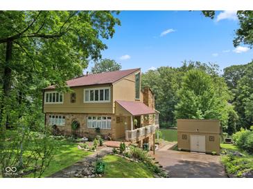 Beautiful two-story home with stone accents, covered porch, and waterfront access to the lake at 1927 E Derby Ct, Martinsville, IN 46151