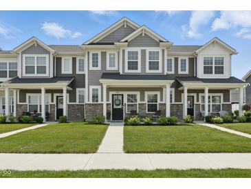 Charming townhome featuring stone accents, well-maintained lawn, and covered front porch at 3613 Lehigh Ave, Westfield, IN 46074