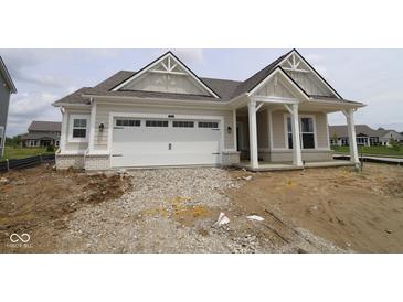 New home features a two-car garage, covered front porch, beige siding, white trim, and gabled roof with architectural details at 3824 Dutton Dr, Bargersville, IN 46106