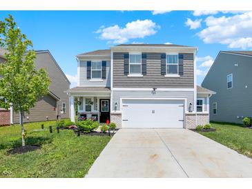 Charming two-story home boasts a manicured front yard and a two-car garage, providing both curb appeal and functionality at 741 Scarsdale Ln, Danville, IN 46122