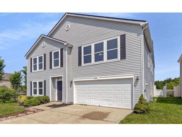 Charming two-story home with gray siding, black shutters, and a two-car garage, enhancing curb appeal at 7854 Wolfgang Pl, Indianapolis, IN 46239