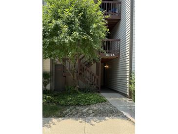 Exterior view of condo building featuring private entrance, stairs, and landscaping at 8176 Shorewalk Dr # C, Indianapolis, IN 46236