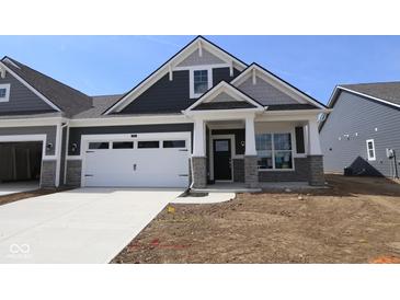New construction exterior showcasing a two-car garage, gray siding, stone accents, and a well-manicured lawn under a clear blue sky at 12516 Morning Ridge Way, Noblesville, IN 46060