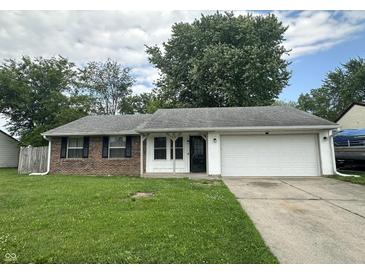Charming single-story home with brick facade, attached garage, and well-maintained front lawn at 3259 Pawnee Dr, Indianapolis, IN 46235