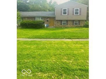 A charming two-story home featuring a well-maintained lawn and welcoming curb appeal at 3570 Decamp Dr, Indianapolis, IN 46226